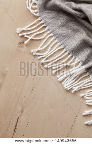 warm wool throw on wooden background