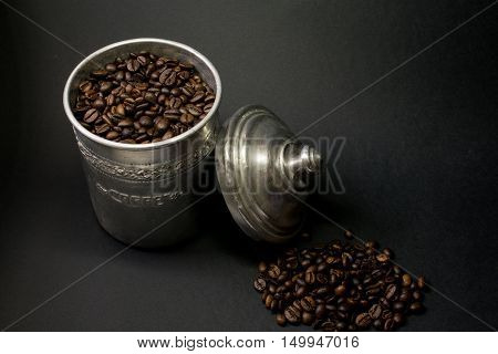 Coffee beans pot in a dark background