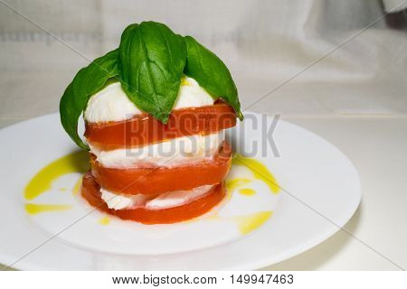 Italian food called caprese with basil cheese and tomato