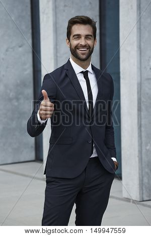 Businessman with thumbs and smiling at camera