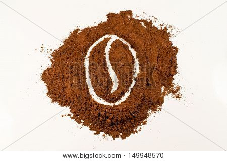 A drawing of a coffee bean in coffee powder