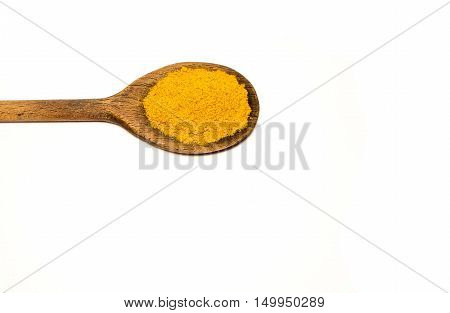 A wooden spoon with curry in a white background