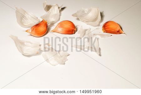 three seeds of garlic in a white background