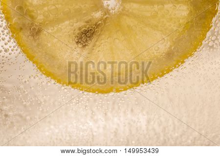 Lemon absorbed in mineral water with bubbles
