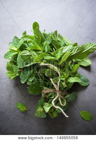 Green fresh mint on the beton table. View from abobe with space for text.