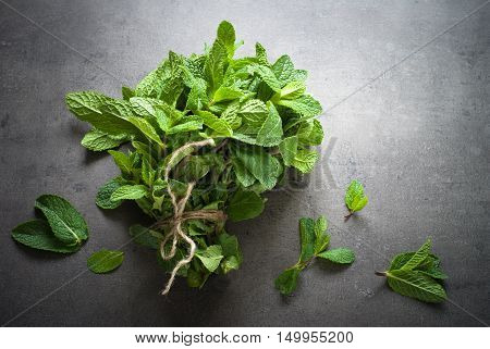 Green fresh mint on the beton table. View from abobe with space for text.