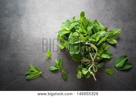 Green fresh mint on the beton table. View from abobe with space for text.