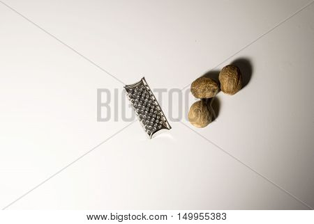 Three nutmeg disposed on a white background