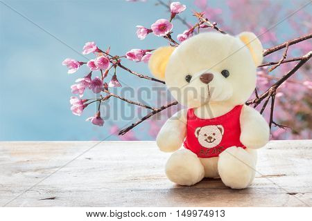 Teddy bears sitting on a wooden floo