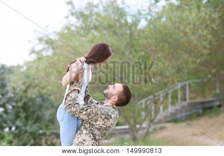 Happy US army soldier with wife in park