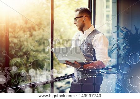 Concept Global Strategy Virtual Icon Diagram Graph Interface Innovations Reserch.Bearded Businessman Wearing Glasses White Shirt Waistcoat Holding Modern Laptop Hands Looking Panoramic Window.Blurred