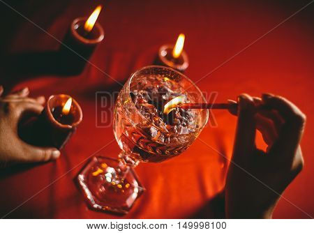 witch holds candle love spell on ritual