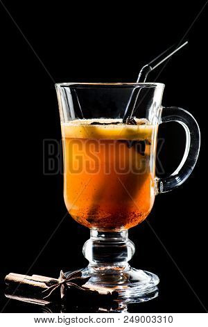 Hot Buttered Becherovka Cocktail With Honey, Cinnamon And Anise Isolated On Black Background