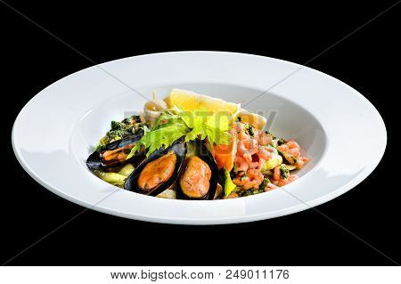 Fresh Seafood Salad With Prepapred Clams, Shrimp And Lemon In A White Plate Isolated On Black Backgr
