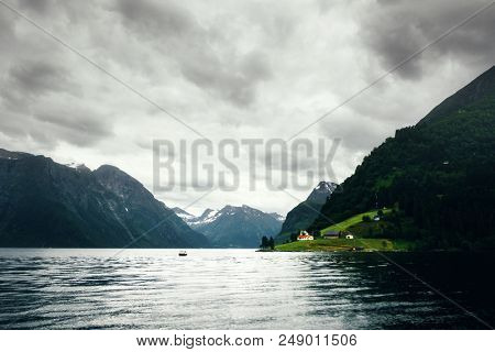 Dramatic evening view of Hjorundfjorden fjord near Urke village, Norway
