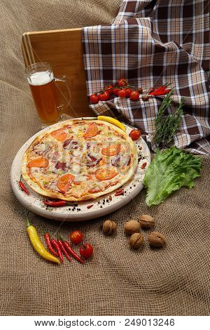 Pizza With Tomato, Cheese, Smoked Sausage, Boiled Sausage, Pepper Spices On A Wooden Tray, With Beer