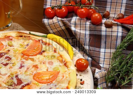 Pizza With Tomato, Cheese, Smoked Sausage, Boiled Sausage, Pepper Spices On A Wooden Tray, With Beer
