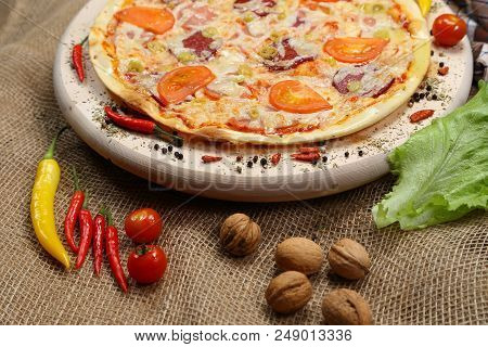 Pizza With Tomato, Cheese, Smoked Sausage, Boiled Sausage, Pepper Spices On A Wooden Tray Close-up