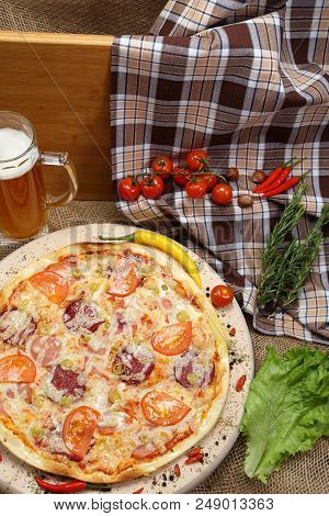 Pizza With Tomato, Cheese, Smoked Sausage, Boiled Sausage, Pepper Spices On A Wooden Tray, With Beer