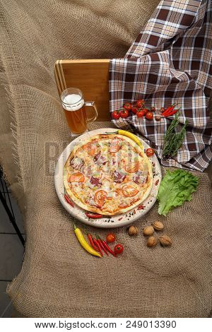 Pizza With Tomato, Cheese, Smoked Sausage, Boiled Sausage, Pepper Spices On A Wooden Tray, With Beer