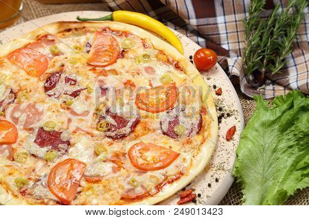 Pizza With Tomato, Cheese, Smoked Sausage, Boiled Sausage, Pepper Spices On A Wooden Tray Close-up