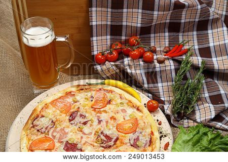 Pizza With Tomato, Cheese, Smoked Sausage, Boiled Sausage, Pepper Spices On A Wooden Tray, With Beer
