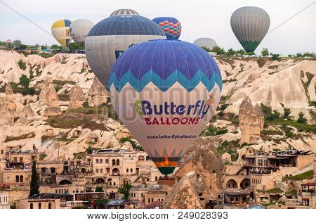 Goreme, Cappadocia, Turkey - Aprile 26, 2018: Hot Air Balloons Flying Over Goreme At Sunrise.