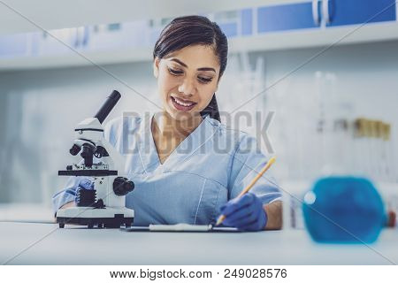 Working Biologist. Appealing Young Promising Biologist Feeling Motivated While Working In Modern Lab