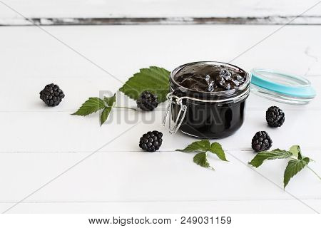 Homemade Blackberry Preserves In A Canning Glass Bail Jar With Attached Lid. Selective Focus On Jam.
