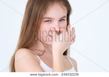 Bad Foul Smell. Stinky Odour. Child Covering Her Nose. Little Girl Portrait On White Background. Fac