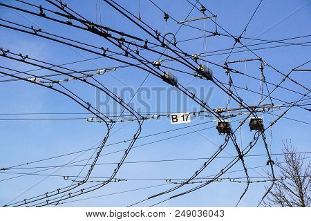 Black Tram Wires Over Blue Sky . Urban Transportation System