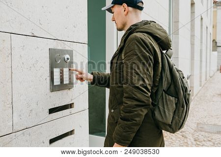 A Male Local Resident Or Tourist Clicks On The Doorphone Button Or Calls The Intercom. Arrival And C
