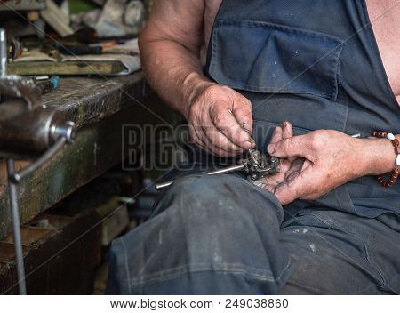 Man Working At Workshop, Close Up On His Hands. Blurred Background, Soft Selective Focus. Older Man 