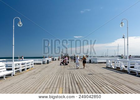 Sopot, Poland - July 27, 2018: Tourists Walking On Wooden Sopot Pier In A Sunny Day. It Is The Longe