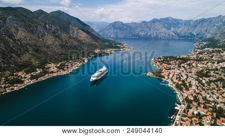 Aerial Beautiful View Of Kotor Bay. Cruise Ship Docked In Beautiful Summer Day. View Of Kotor Old To