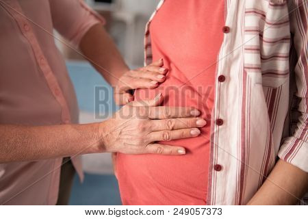 Pink Nails. Mature Woman With Nice Pink Nail Art Feeling Extremely Delightful While Touching Pregnan
