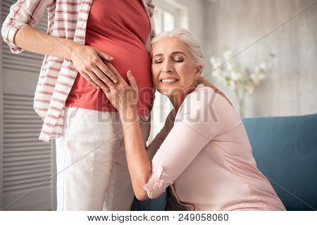 Baggy Clothes. Expecting Woman Wearing Nice Fashionable Baggy Clothes Standing Near Her Mother