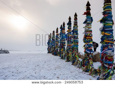 Wooden Ritual Pillars With Colorful Ribbons On Cape Burkhan, Lake Baikal, Olkhon Island, Siberia, Ru