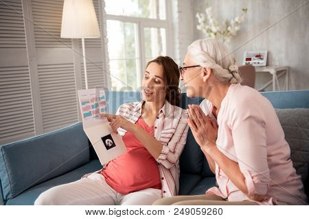 Enthusiastic Mother. Smiling Loving Mother Feeling Enthusiastic Looking At Med Results Of Pregnant D