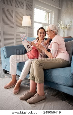 Beige Trousers. Smiling Loving Caring Mother Feeling Enthusiastic Looking At Med Results Of Pregnant