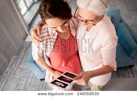 Pregnant Friend. Happy Professional Experienced Gynecologist Feeling Amazing While Hugging Her Pregn