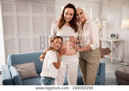 Making Photo. Expecting Young Appealing Woman Making Memorable Photo With Her Mother And Daughter