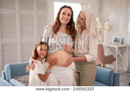 Dark-haired Woman. Beaming Stylish Dark-haired Expecting Woman Spending Time With Her Family Members