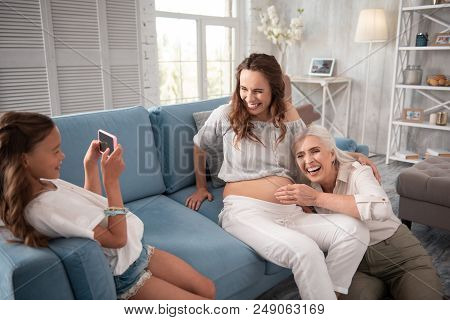 Photo With Mother. Pregnant Woman Laughing Out Loud While Making Photo With Her Emotional Mother
