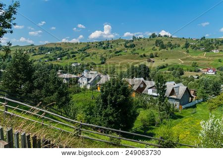The Street Of The Carpathian Village On The Valley With A Dense Number Of Buildings