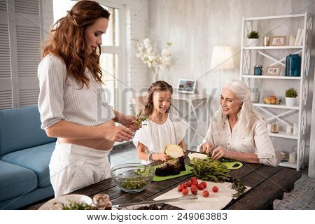 Salad With Arugula. Expecting Caring Woman Holding Arugula While Cooking Healthy Salad For Her Famil