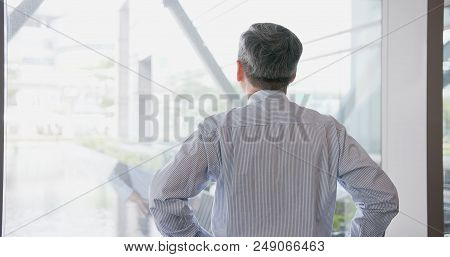 Old Businessman Back To You And Look Somewhere