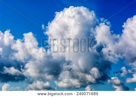 Clear Blue Sky With Cumulonimbus Thunderstorm Clouds Background. Bad Weather Harbinger Concept
