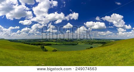 Bright Sunlight Warms The Green Crops And Grassland Of The Blackmore And Wardour Vales On The Dorset