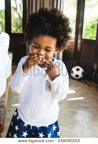 Kid having fun eating watermelon